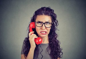 aggravated woman on red phone