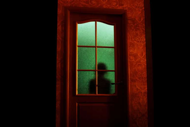 spooky figure in door