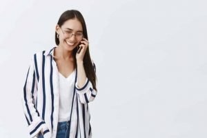 woman smiling speaking on phone