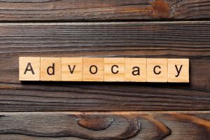 ADVOCACY word written on wood block. ADVOCACY text on wooden table for your design, concept.
