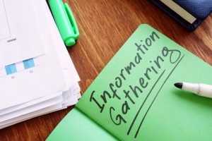 information gathering written on a notepad