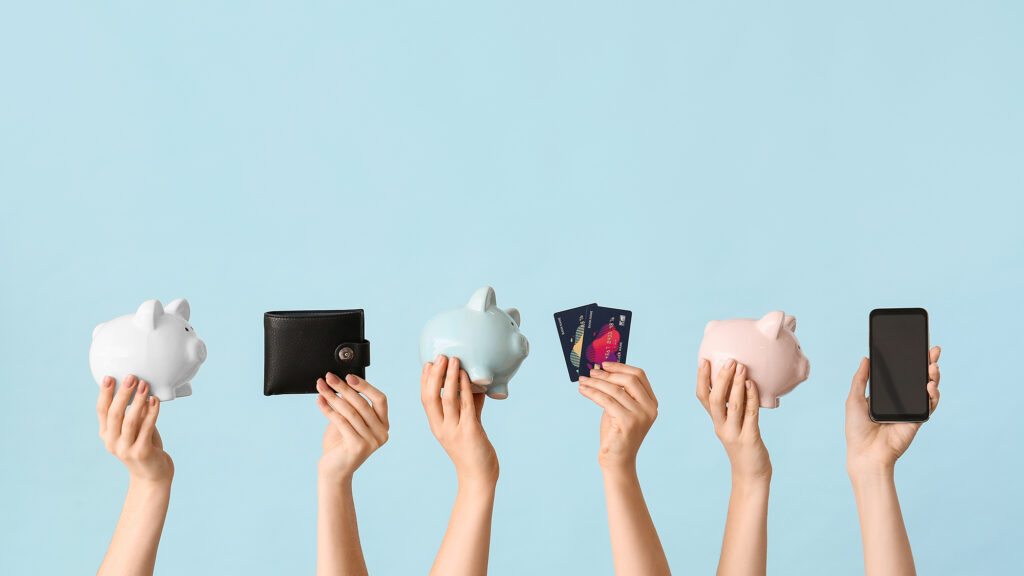 venmo for nonprofits Female hands with piggy banks, credit cards, wallet and mobile p