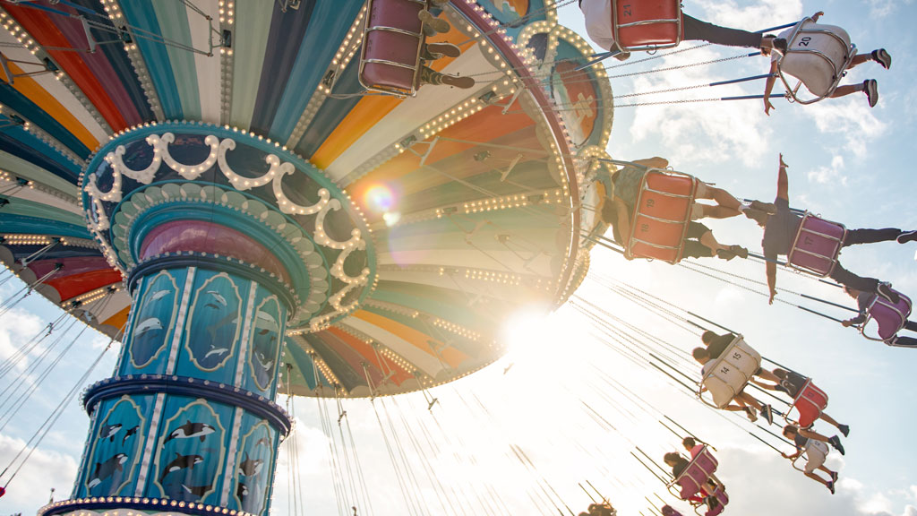 Illustrative photo of carnival-goers on a whirligig carnival ride