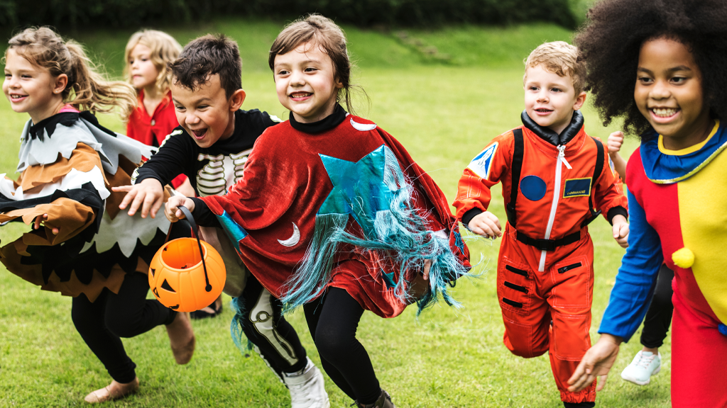 Photo of a group of children in Halloween costumes running during a fall costume contest fundraiser