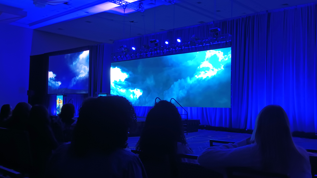 Photo of the 2026 Bridge Conference keynote stage with dark and stormy lighting