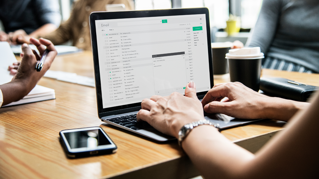 Illustrative photo of a person crafting fundraising emails on their laptop
