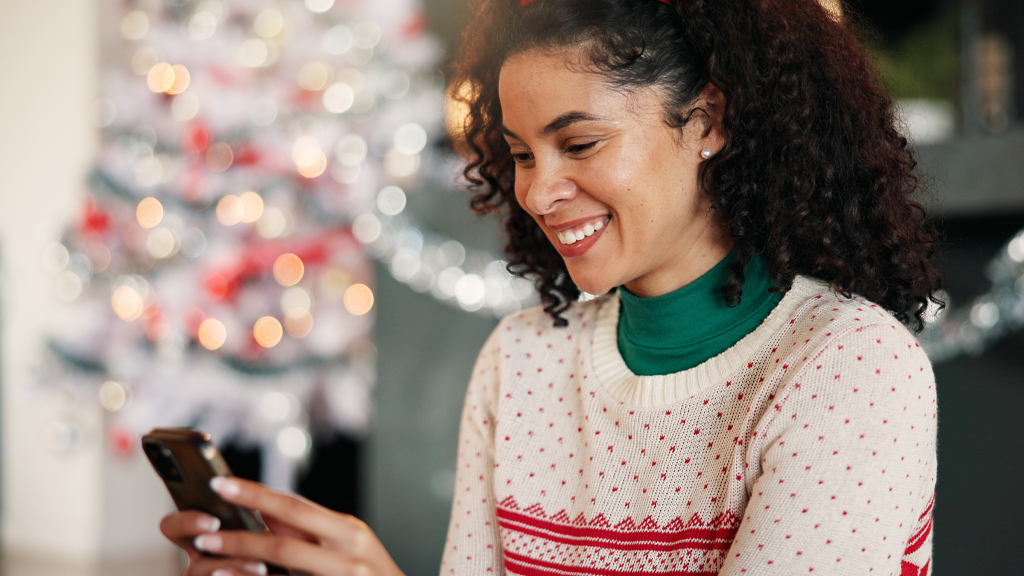 Photo of a woman donating via mobile giving during the Christmas and year-end giving season