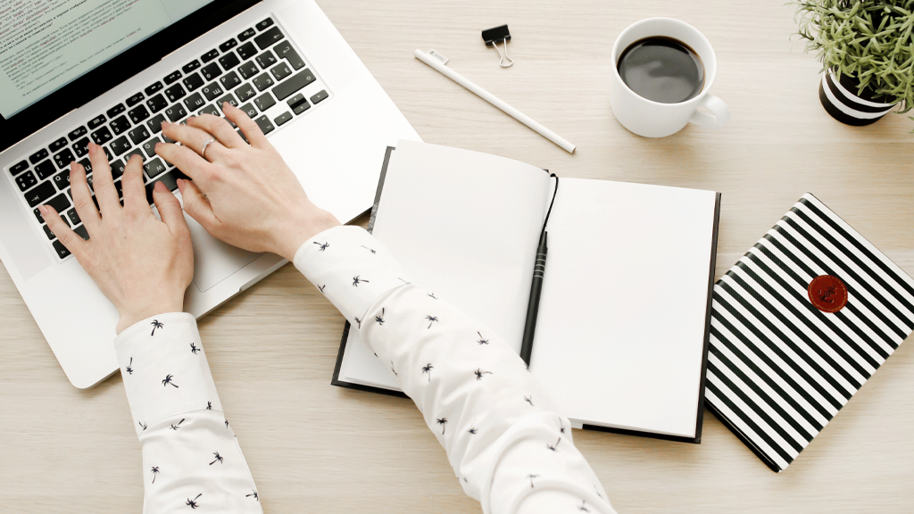Illustrative photo of a person at a laptop writing fundraising email subject lines